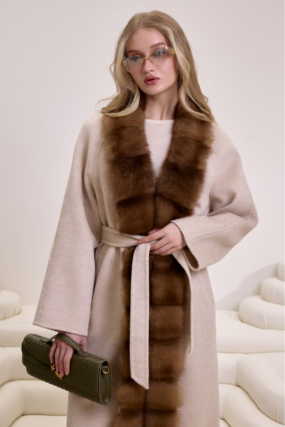 Long beige cashmere coat featuring soft brown mink fur detailing, perfect for refined seasonal dressing.