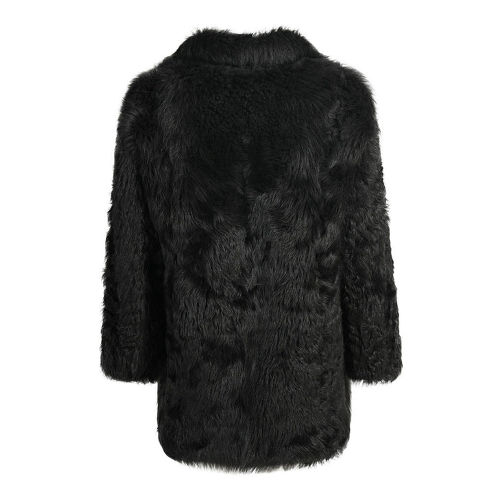 Plush black shearling coat tailored to flatter fuller figures, combining classic style with thick, warm fabric ideal for colder weather.