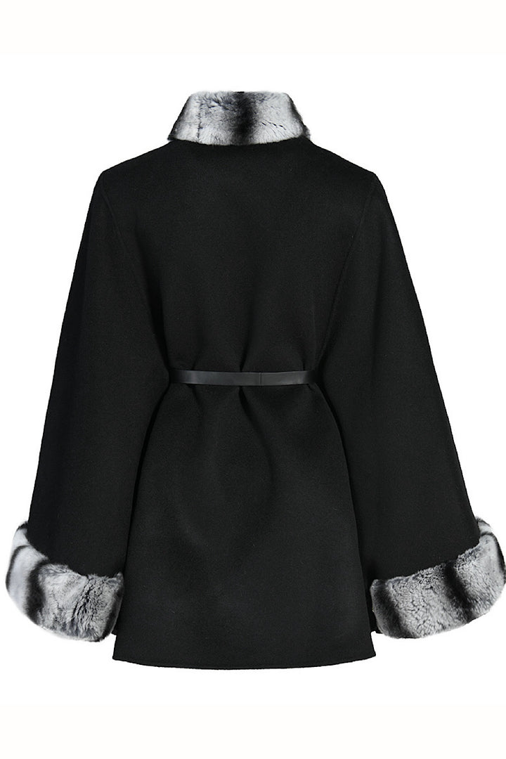Timeless plus-size cashmere cape designed to enhance fuller figures, complete with a rex rabbit fur collar and adjustable leather belt.